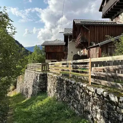 Mountain house with two barns and a garden