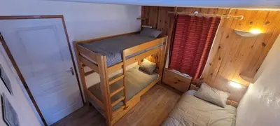 Un ou plusieurs lits dans un hébergement de l'établissement La Mourra Appartement 5 personnes